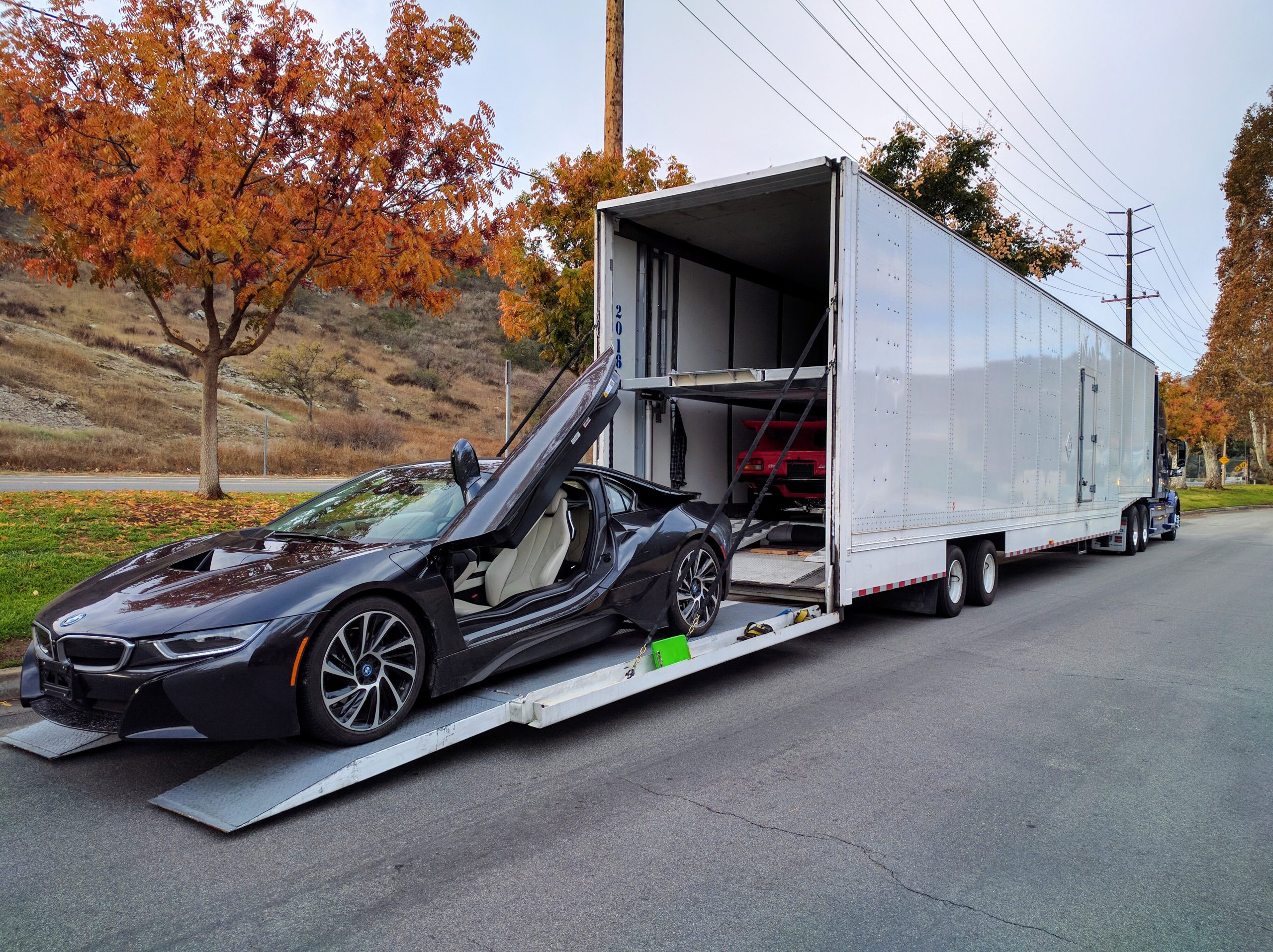 Luxury car being loaded into enclosed trailer for safe and secure auto shipping.