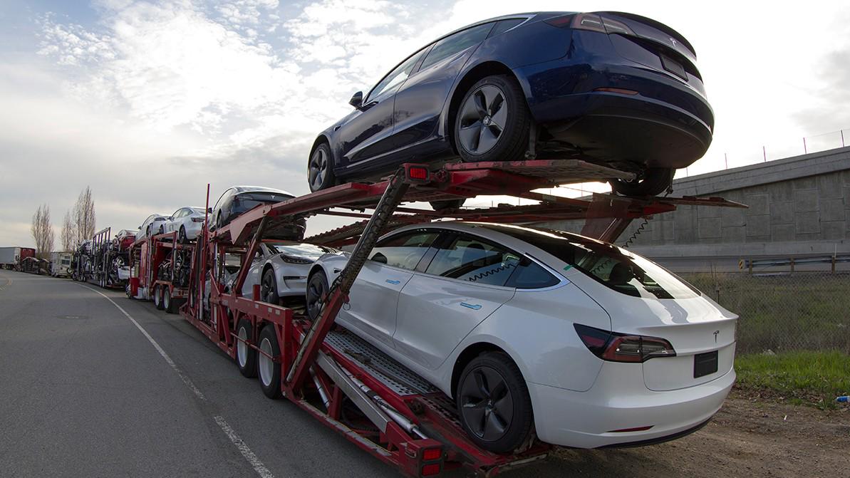 Car carrier hauling Teslas for export – Ultimate Guide to International Car Shipping.